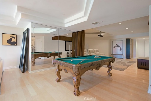 rec room featuring pool table, light hardwood / wood-style flooring, and a raised ceiling