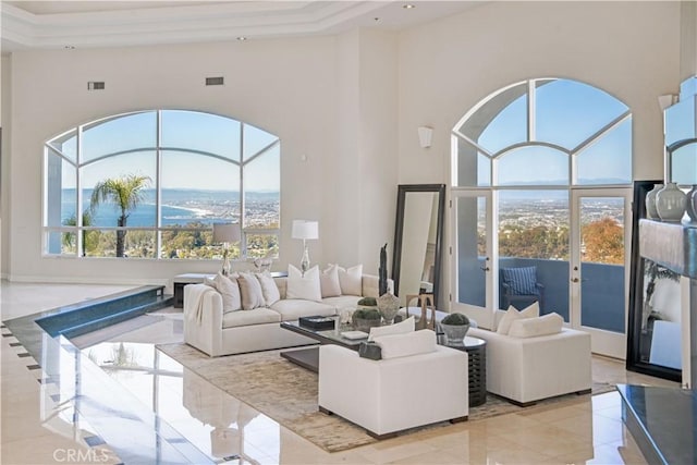 living room featuring a wealth of natural light and a high ceiling