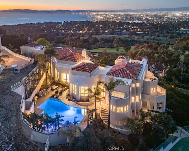 aerial view at dusk with a water view