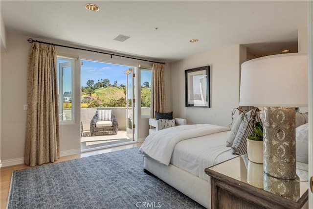 bedroom featuring hardwood / wood-style floors and access to outside