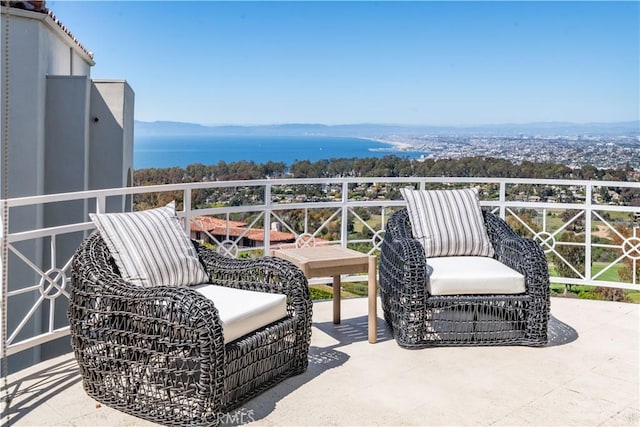 balcony featuring a water view and a patio