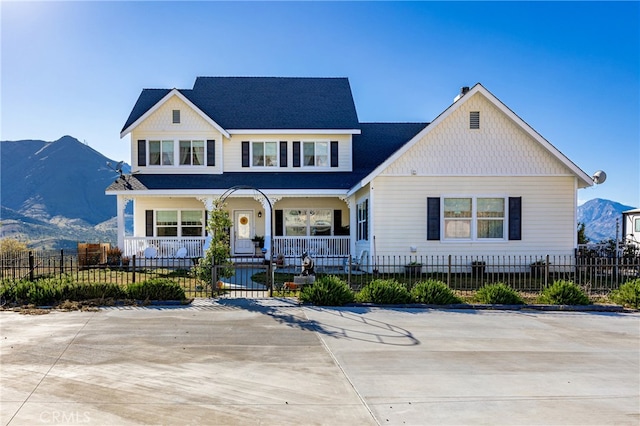 view of front of property with a mountain view and covered porch