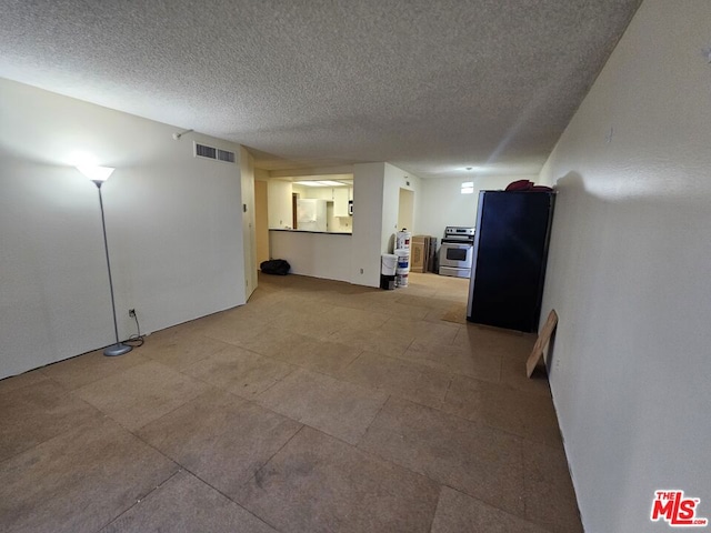 spare room featuring a textured ceiling