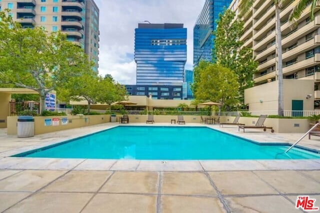 view of swimming pool with a patio area