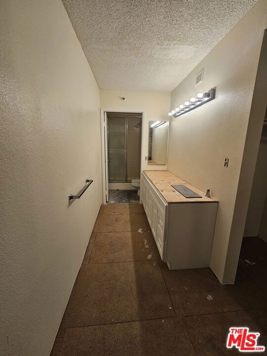 bathroom featuring vanity and a textured ceiling