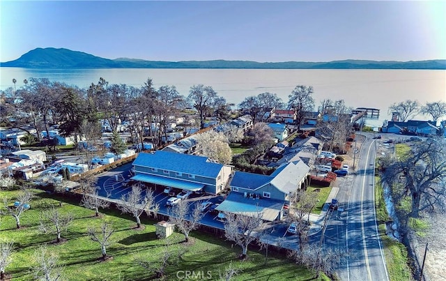 drone / aerial view featuring a water and mountain view