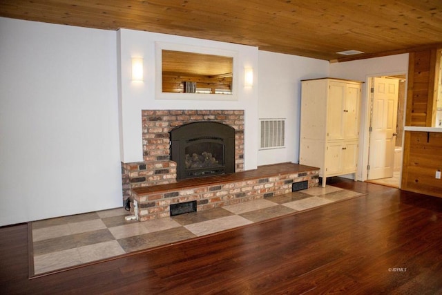 unfurnished living room with wood ceiling, wood-type flooring, and a brick fireplace