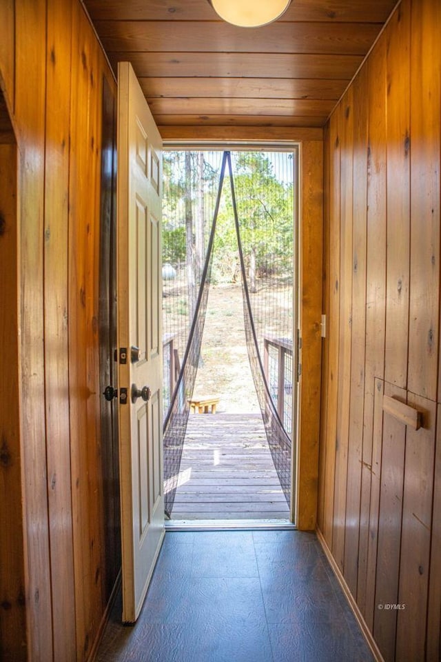 doorway with wooden walls and wooden ceiling