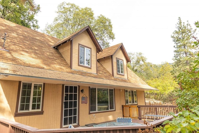 back of house featuring a wooden deck