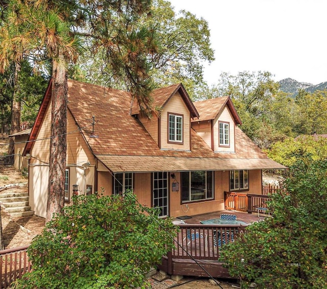 back of property featuring a deck