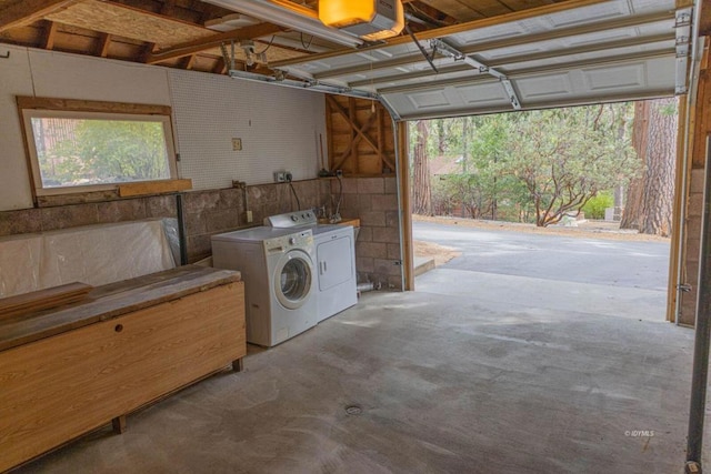 garage featuring separate washer and dryer and a garage door opener