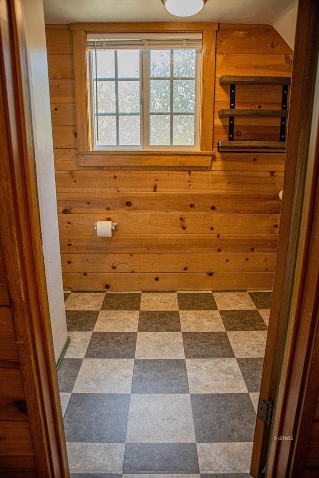 bathroom with wood walls