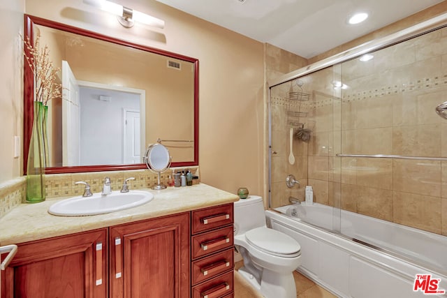 full bathroom featuring toilet, tasteful backsplash, tile floors, shower / bath combination with glass door, and vanity