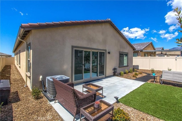 rear view of house with a lawn, a patio area, and central air condition unit