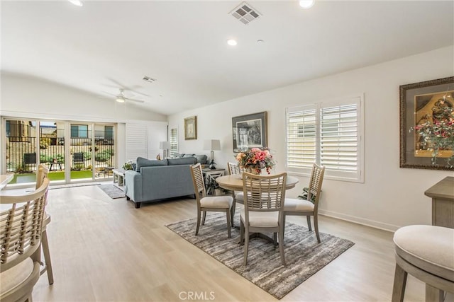 dining room featuring ceiling fan, light hardwood / wood-style flooring, and vaulted ceiling