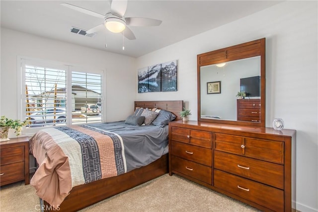bedroom featuring ceiling fan and light carpet