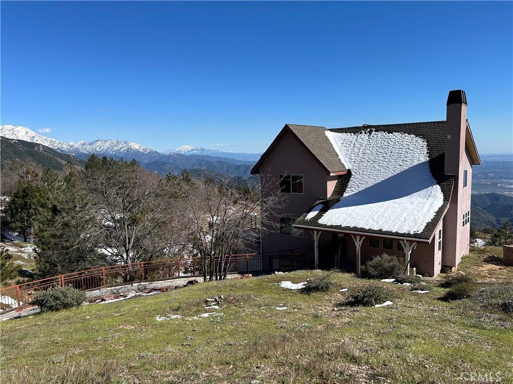 view of home's exterior featuring a mountain view and a yard