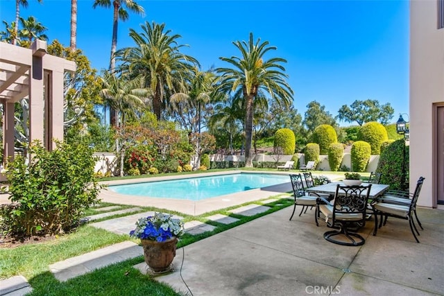 outdoor pool featuring fence, outdoor dining area, and a patio