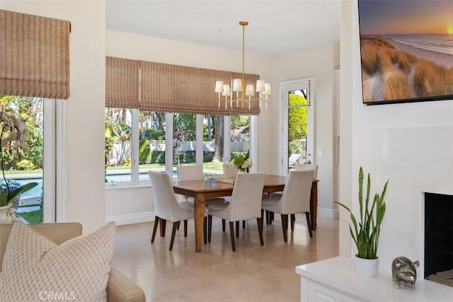 dining space featuring baseboards and an inviting chandelier