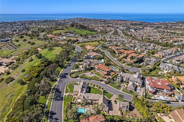 drone / aerial view with a water view and a residential view