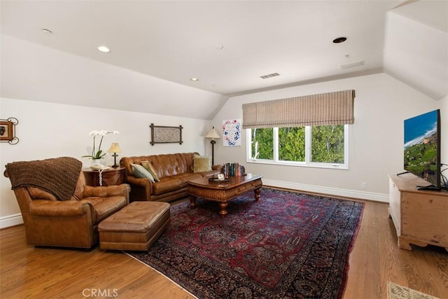 living area with visible vents, baseboards, lofted ceiling, wood finished floors, and recessed lighting