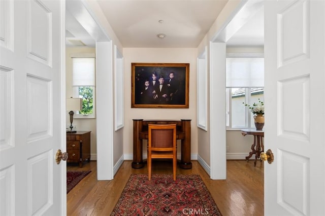 interior space featuring light wood-type flooring and baseboards