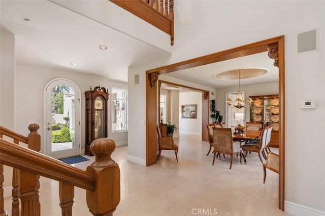 entrance foyer with recessed lighting, an inviting chandelier, baseboards, and stairs