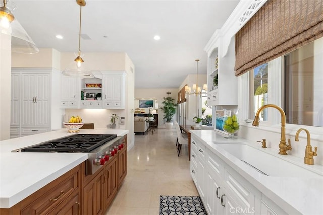 kitchen with white cabinetry, stainless steel gas cooktop, open shelves, and a sink