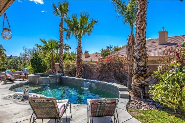 view of swimming pool with a patio area, an in ground hot tub, and pool water feature