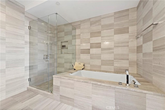 bathroom with tile patterned flooring and separate shower and tub