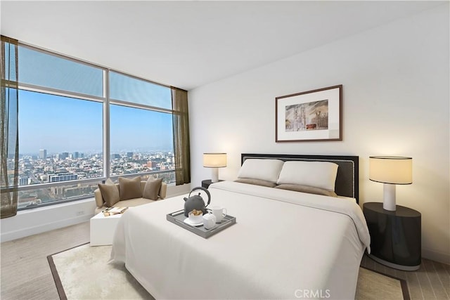 bedroom featuring multiple windows and light hardwood / wood-style flooring