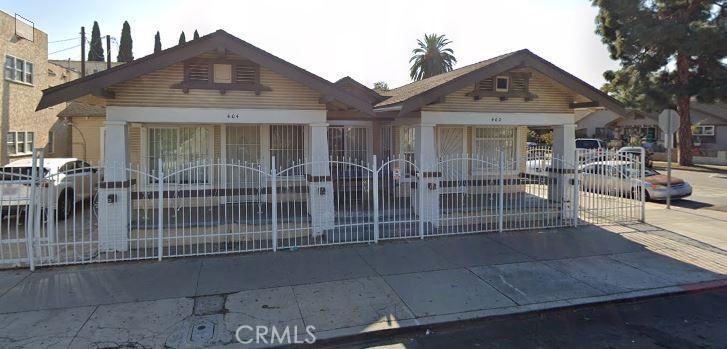 bungalow-style home featuring fence