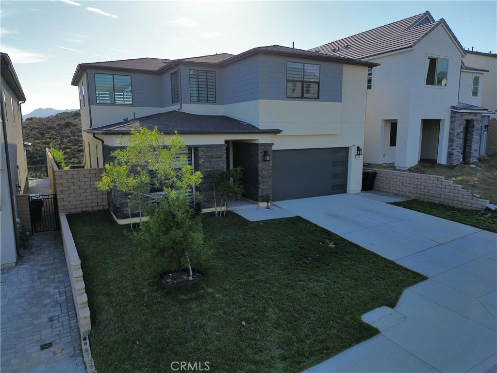 view of front of home featuring a garage and a front lawn