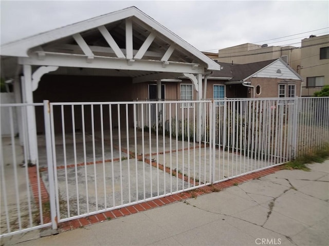 view of gate featuring a carport