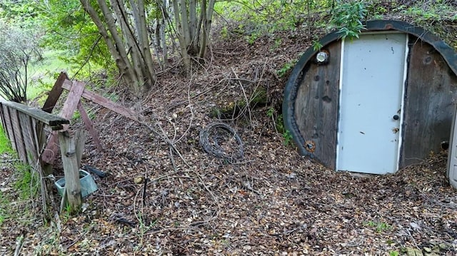 view of storm shelter featuring an outbuilding