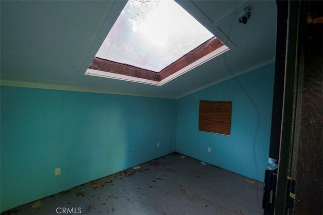 bonus room with lofted ceiling with skylight