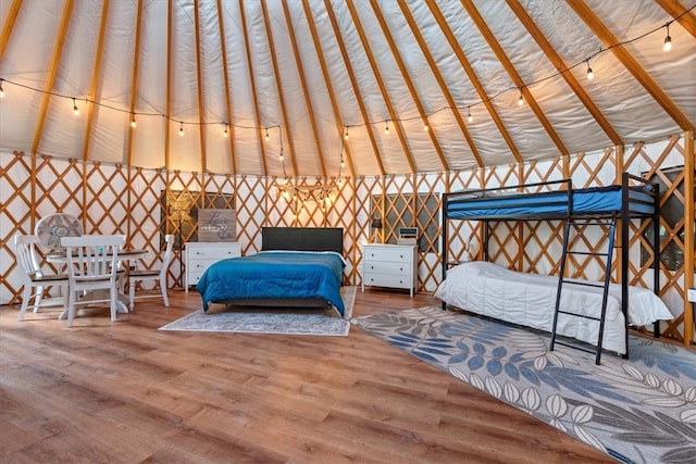 unfurnished bedroom featuring vaulted ceiling and hardwood / wood-style flooring