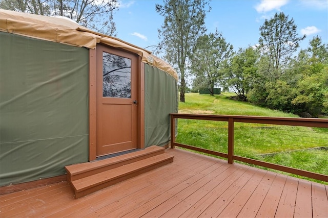 wooden terrace with a yard