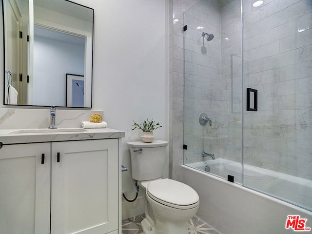 full bathroom with toilet, shower / bath combination with glass door, tile floors, and vanity