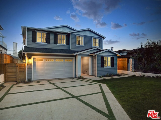 view of front of home with a lawn and a garage