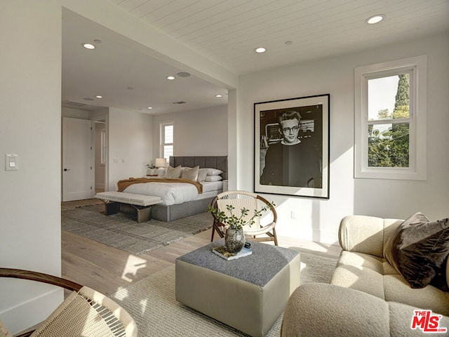 bedroom with multiple windows and light hardwood / wood-style flooring