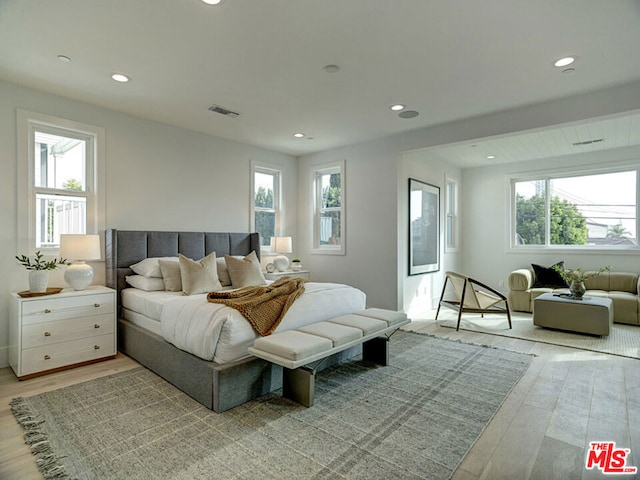 bedroom featuring multiple windows and light wood-type flooring