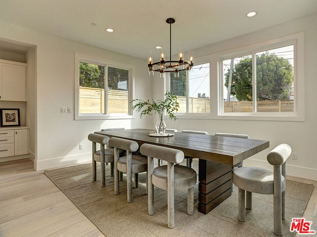 dining room with an inviting chandelier, light hardwood / wood-style floors, and a healthy amount of sunlight