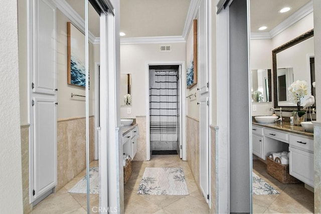 bathroom with tile patterned floors, vanity, and crown molding