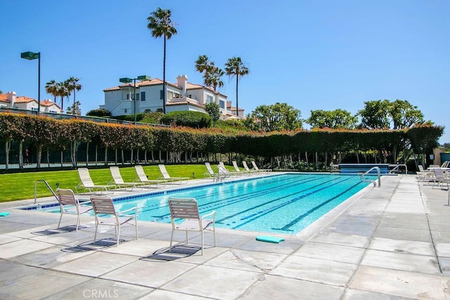 view of pool with a yard and a patio