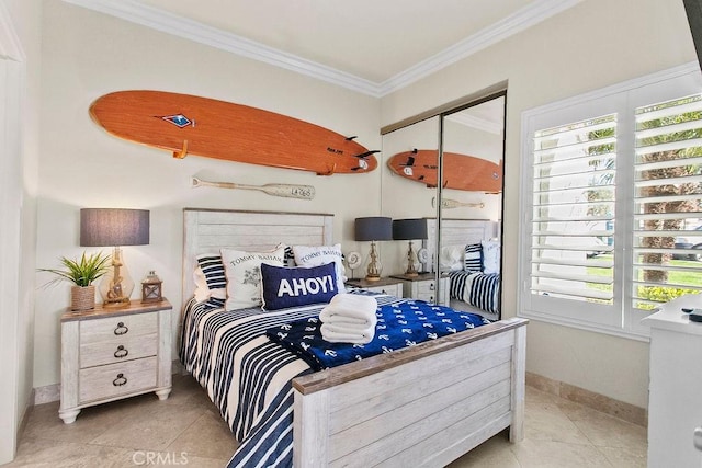 bedroom with ornamental molding, light tile patterned floors, and a closet