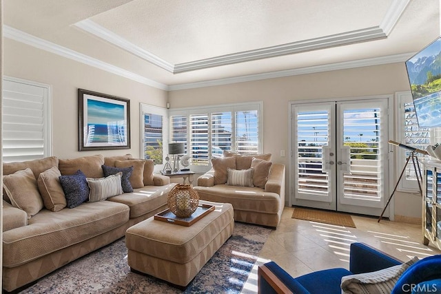 living room featuring a raised ceiling, crown molding, and french doors