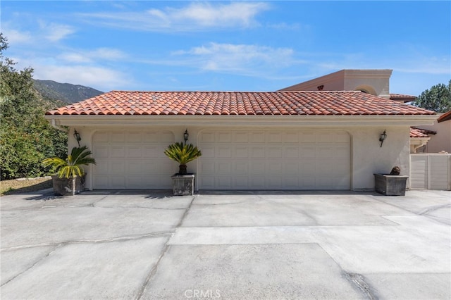 mediterranean / spanish-style home with a mountain view and a garage