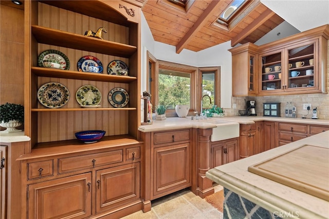 kitchen with lofted ceiling with skylight, sink, decorative backsplash, and wooden ceiling