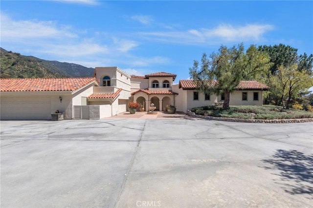 mediterranean / spanish home featuring a mountain view and a garage